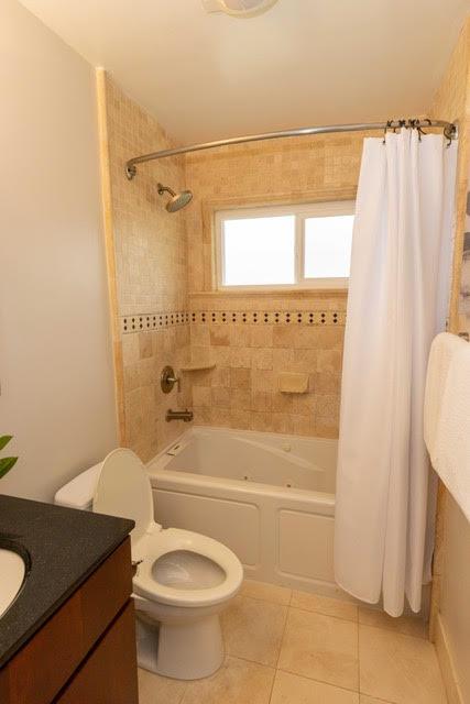 1609 Bonita Avenue, Unit 5 Berkeley, CA 94709 - Photo 13 of 17 a bathroom with a granite countertop sink toilet and shower