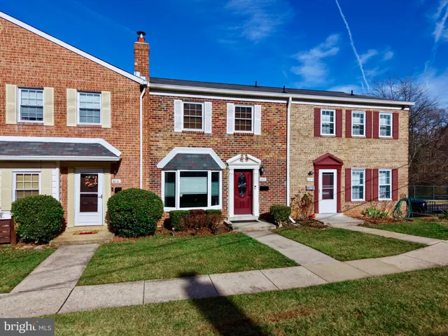 front view of a brick house with a yard