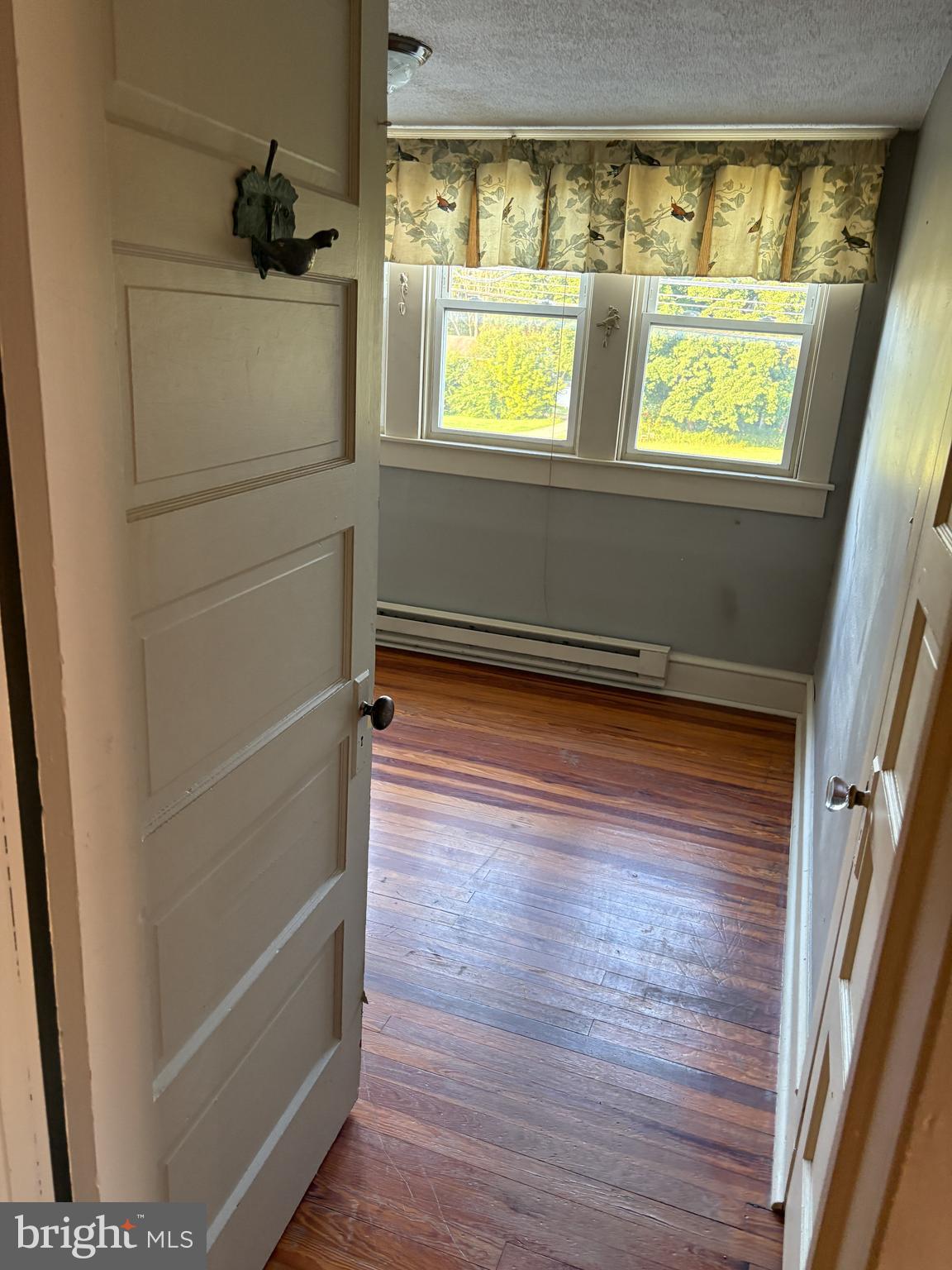 1906 Hanover Pike Hampstead, MD 21074 - Photo 20 of 45 a view of empty room with window and wooden floor