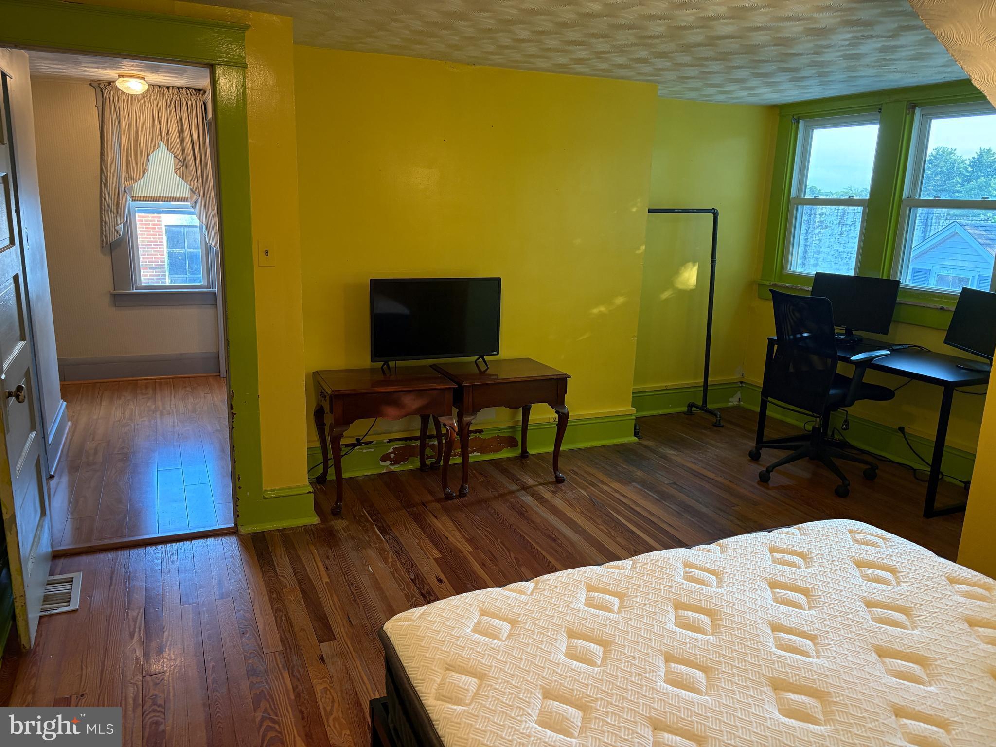 1906 Hanover Pike Hampstead, MD 21074 - Photo 29 of 45 a living room with a table chairs and a flat screen tv