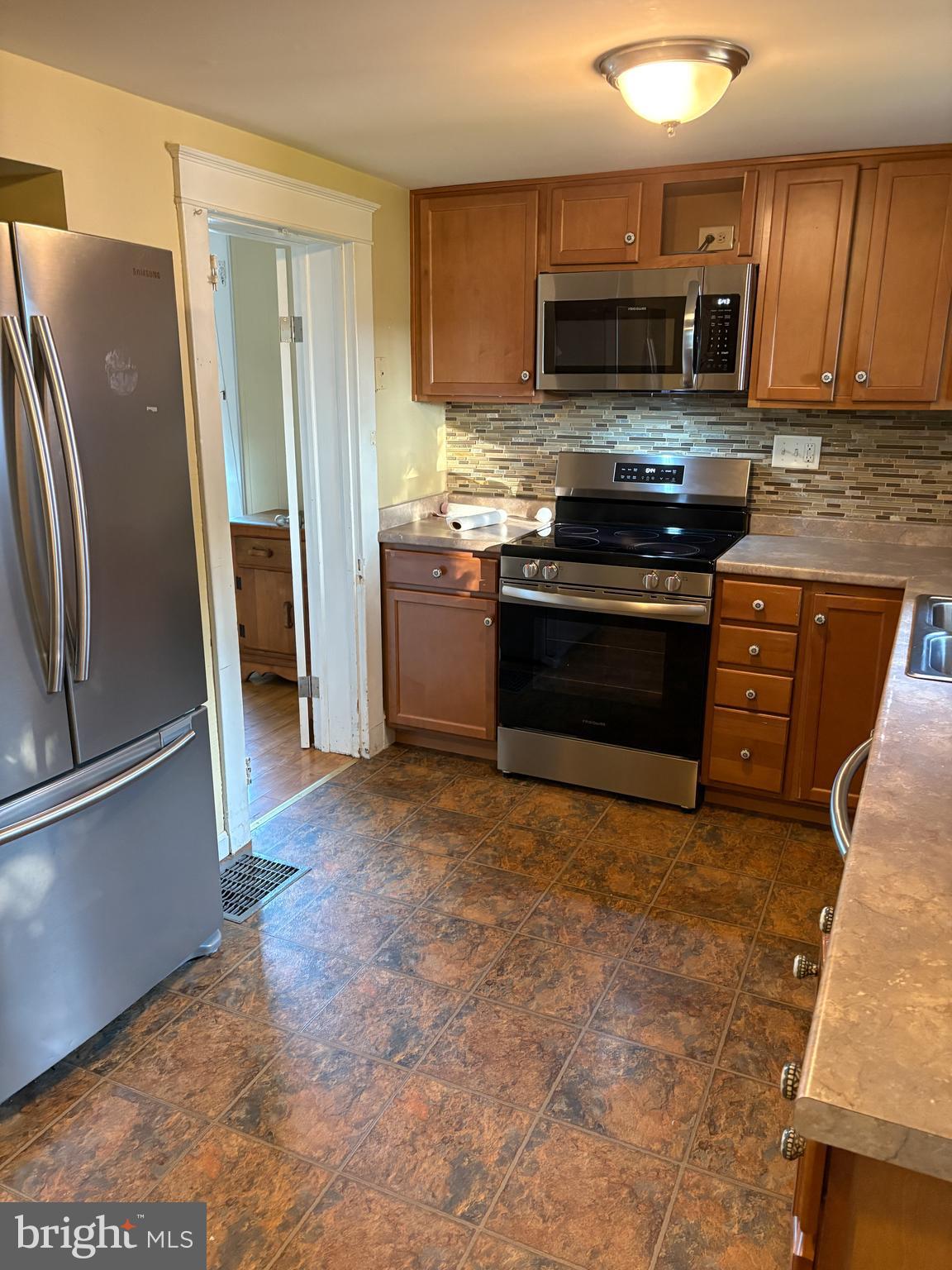 1906 Hanover Pike Hampstead, MD 21074 - Photo 7 of 45 a kitchen with stainless steel appliances and a stove top oven