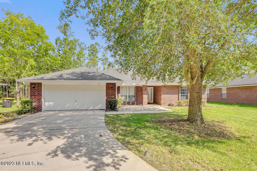 1399 Guardian Drive Jacksonville, FL 32221 - Photo 1 of 29 a front view of a house with yard and tree