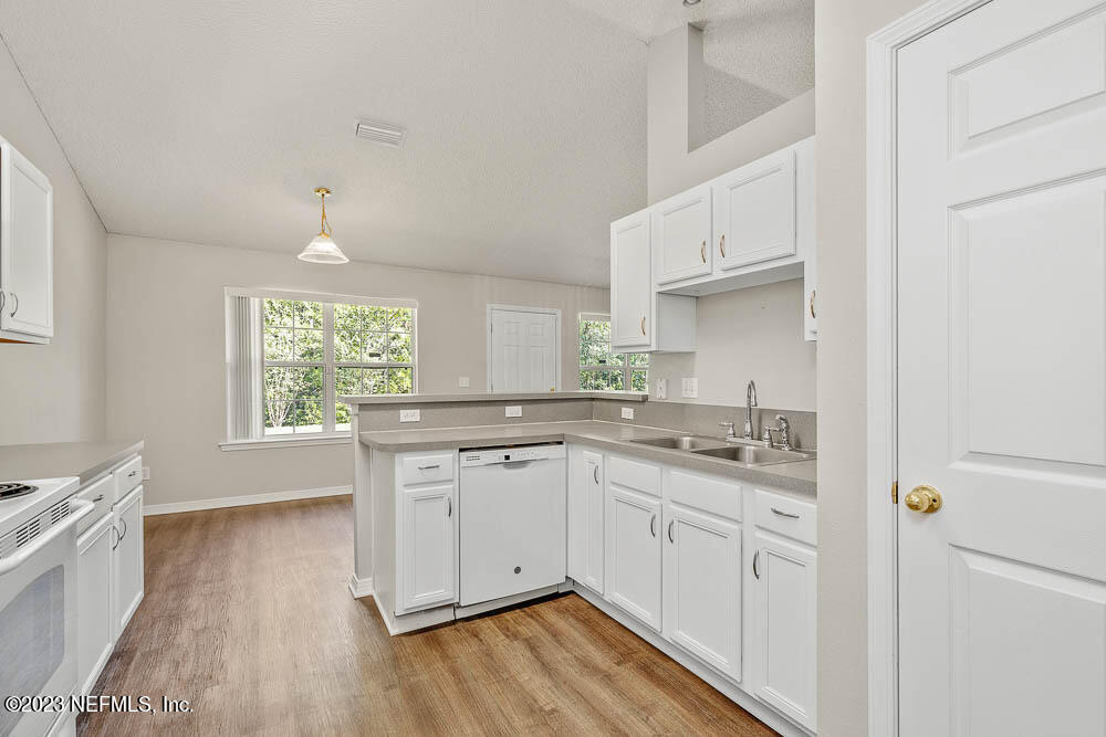 1399 Guardian Drive Jacksonville, FL 32221 - Photo 12 of 29 a kitchen with white cabinets appliances and a window