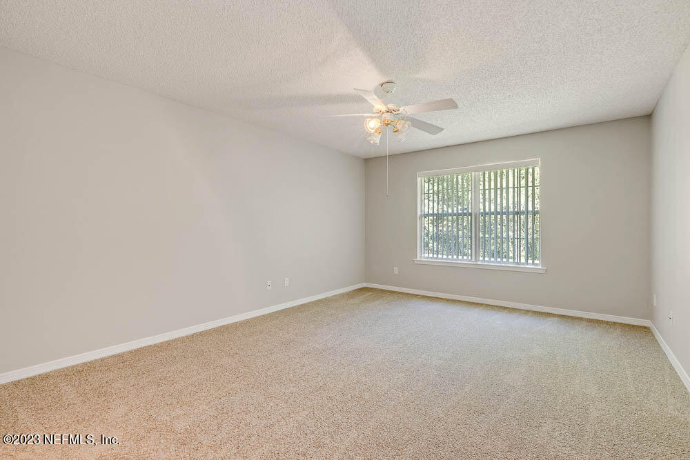 1399 Guardian Drive Jacksonville, FL 32221 - Photo 21 of 29 an empty room with a window and a ceiling fan