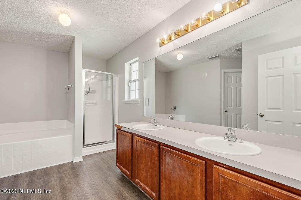 1399 Guardian Drive Jacksonville, FL 32221 - Photo 23 of 29 a bathroom with a sink double vanity granite tub shower and a mirror