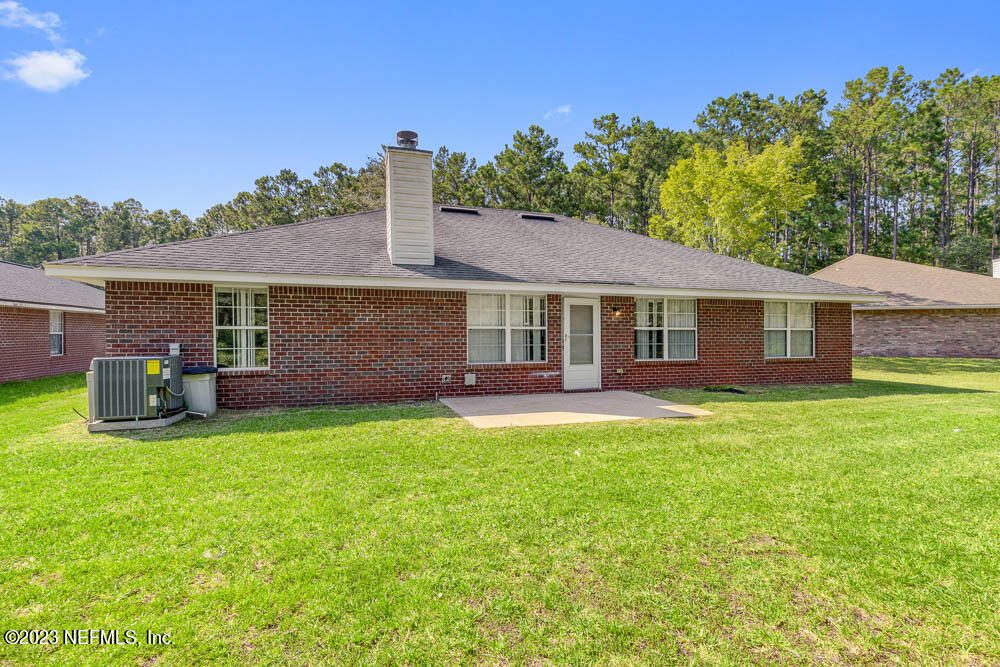 1399 Guardian Drive Jacksonville, FL 32221 - Photo 27 of 29 a front view of a house with a garden and porch