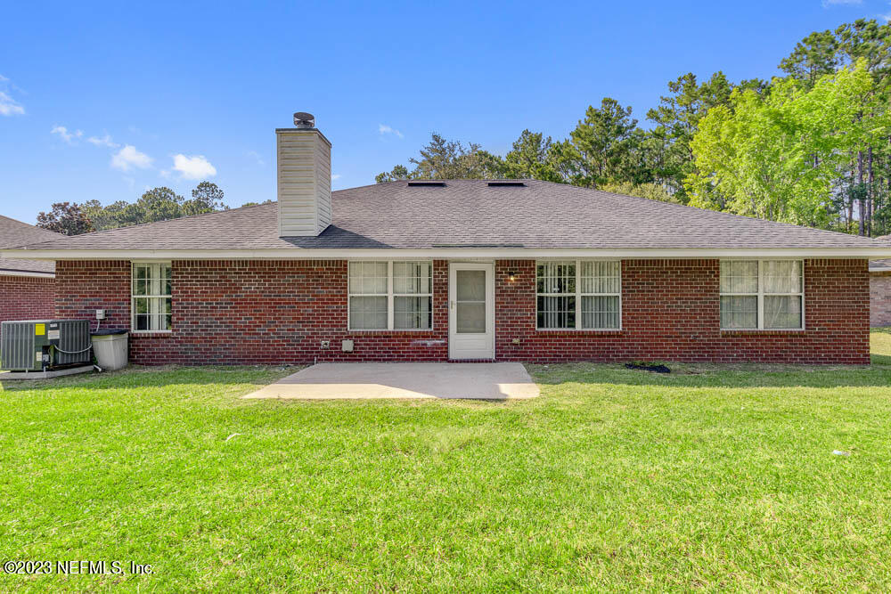 1399 Guardian Drive Jacksonville, FL 32221 - Photo 28 of 29 a front view of a house with a garden and yard