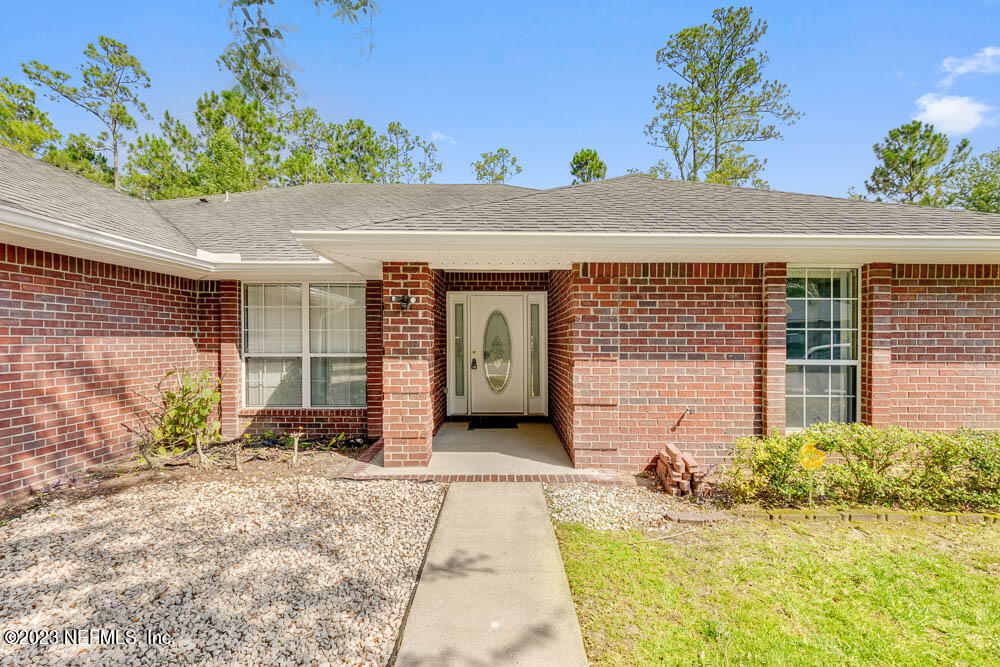 1399 Guardian Drive Jacksonville, FL 32221 - Photo 4 of 29 a front view of a house with a yard