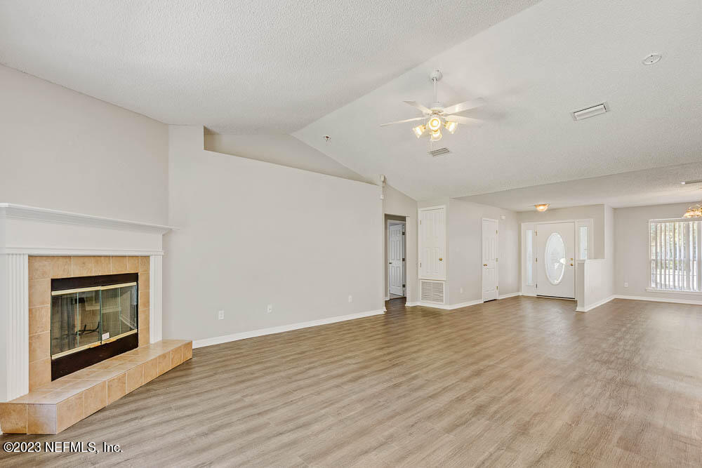 1399 Guardian Drive Jacksonville, FL 32221 - Photo 9 of 29 a view of an empty room with chandelier fan and fire place