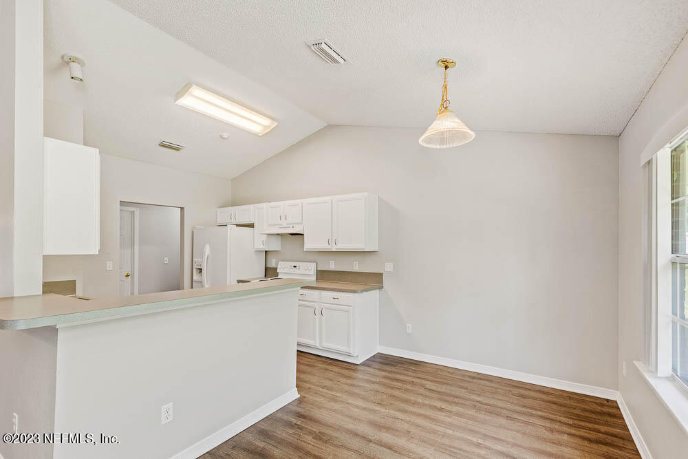 1399 Guardian Drive Jacksonville, FL 32221 - Photo 10 of 29 a kitchen with a refrigerator a stove top oven a sink and dishwasher