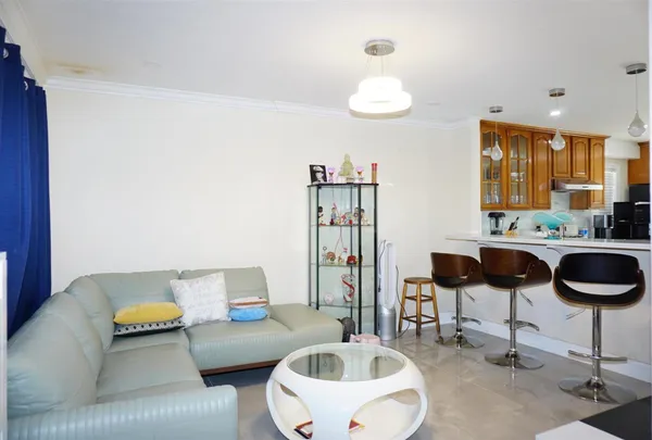 a living room with furniture and a large mirror