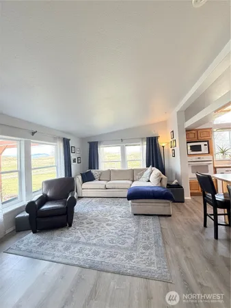 a living room with furniture window and a flat screen tv