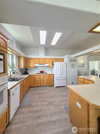 a large kitchen with a large counter top and stainless steel appliances