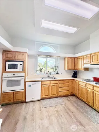 a large kitchen with granite countertop a stove top oven