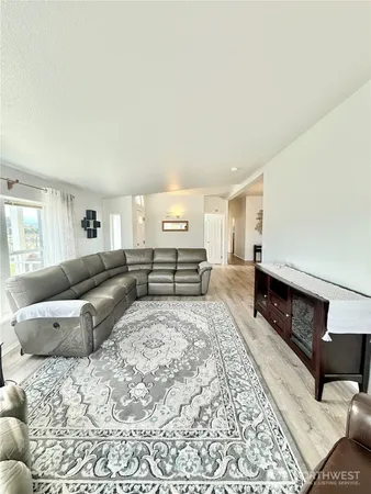 a large bedroom with a bed and a couch