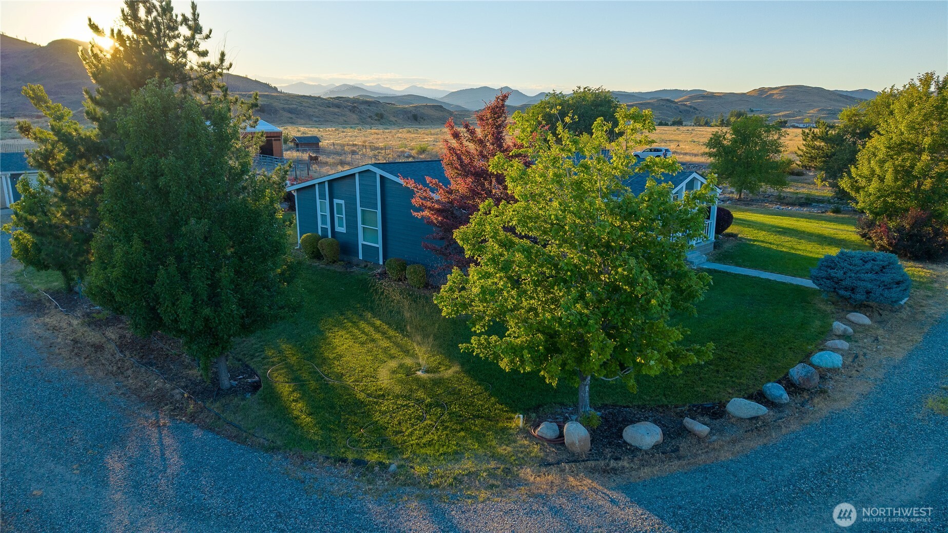 111 Johnson Creek Road Omak, WA 98841 - Photo 3 of 37 a view of a house with a yard and a garden