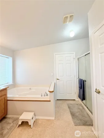a bathroom with a bathtub and a sink