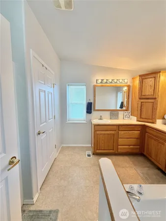 a room with a bed and a dresser