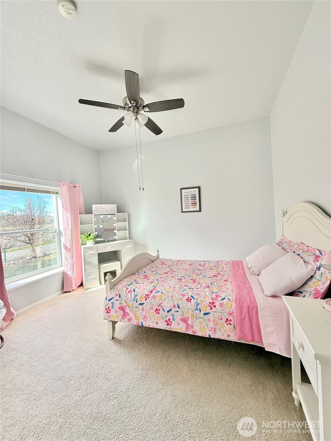 111 Johnson Creek Road Omak, WA 98841 - Photo 33 of 37 a bedroom with a bed and a chandelier