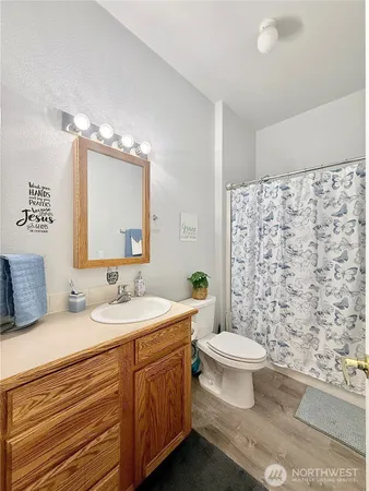 a bathroom with a toilet sink and mirror