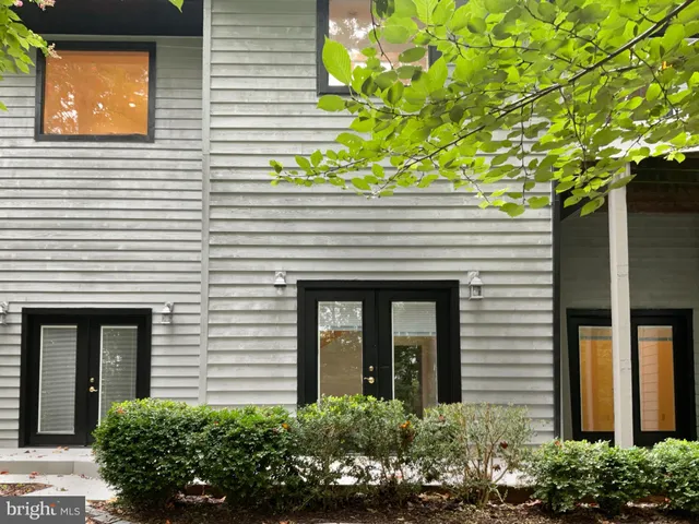 a front view of a house with plants