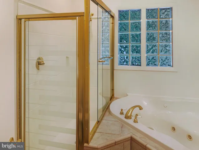 a bathroom with a tub and shower