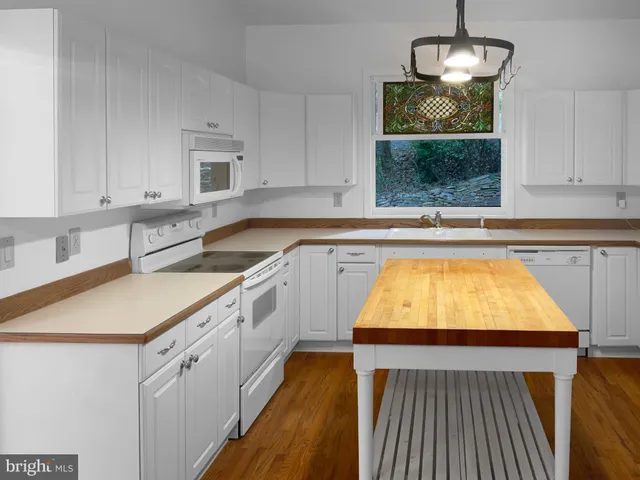 a kitchen with wooden cabinets and sink