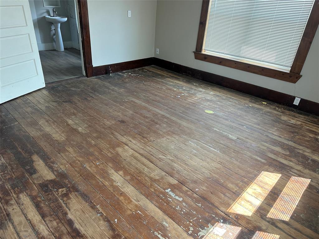 801 East Gentry Street Hamilton, TX 76531 - Photo 12 of 21 a view of a room with wooden floor and window