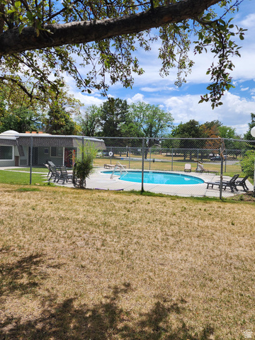 46 Lester Avenue, Unit G 24 Murray, UT 84107 - Photo 3 of 16 Fenced in-ground swimming pool with surrounding patio decking
