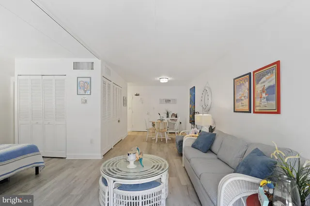 a bedroom with a large bed and a tv on the dresser