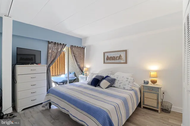 a bedroom with furniture and a flat screen tv