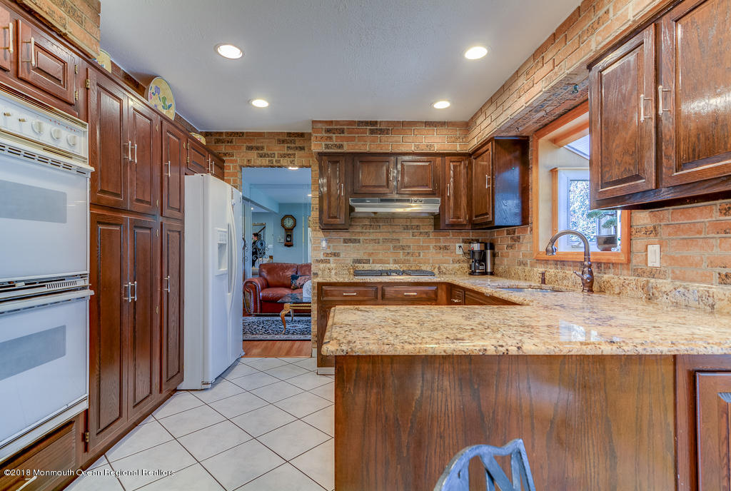 6 South Westfield Road Howell, NJ 07731 - Photo 8 of 21 a kitchen with a refrigerator and a sink