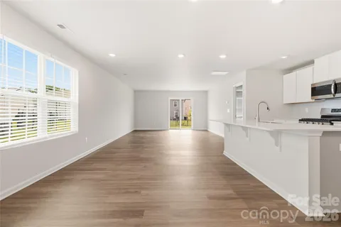 a view of kitchen with microwave and window