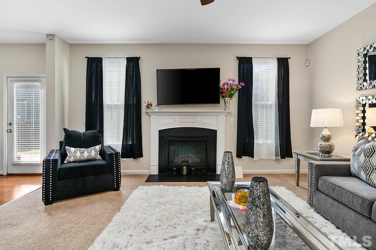 3540 Eastern Branch Road Raleigh, NC 27610 - Photo 11 of 35 a living room with furniture a flat screen tv and a fireplace