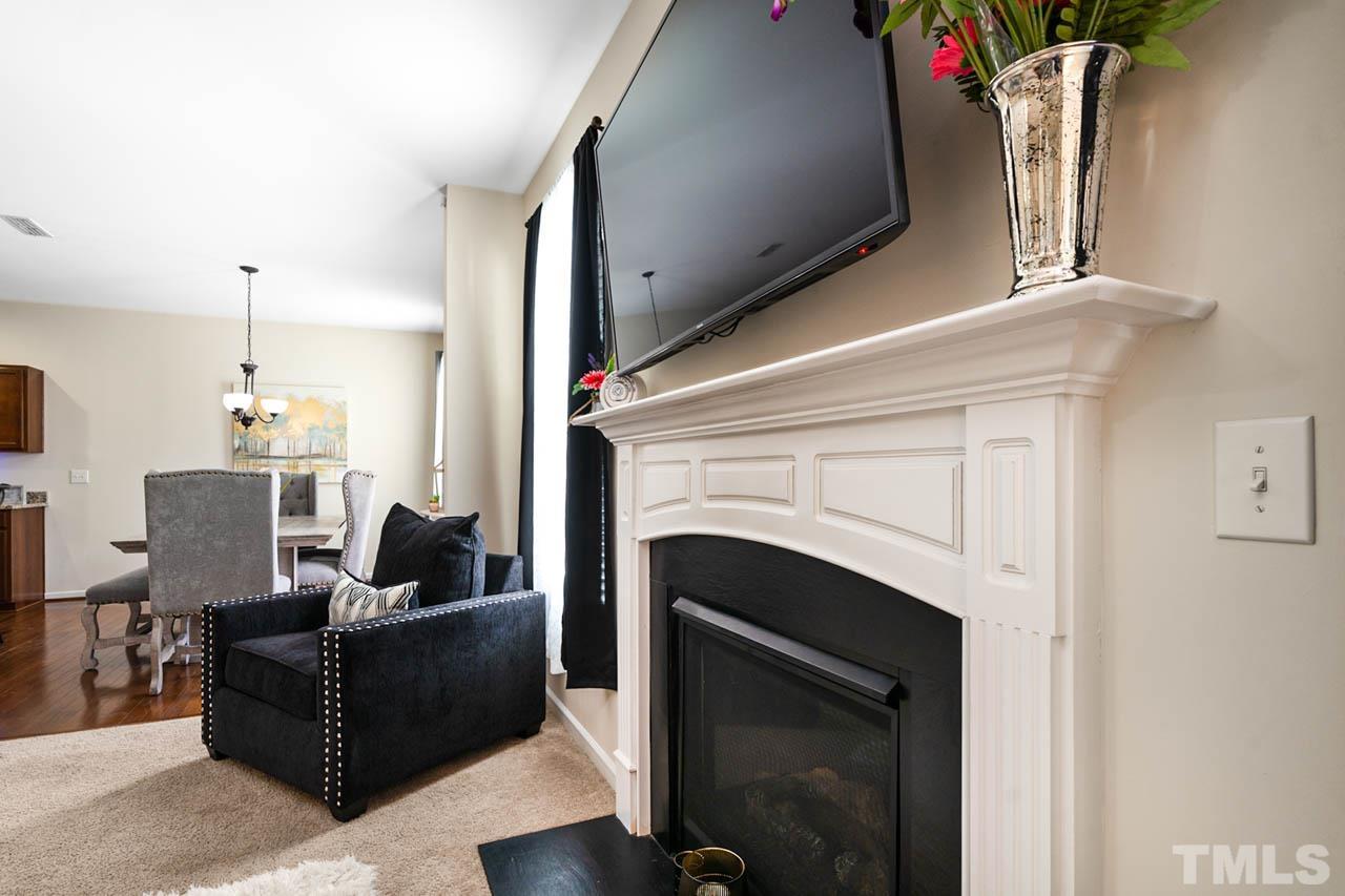 3540 Eastern Branch Road Raleigh, NC 27610 - Photo 12 of 35 a living room with furniture a fireplace and a flat screen tv