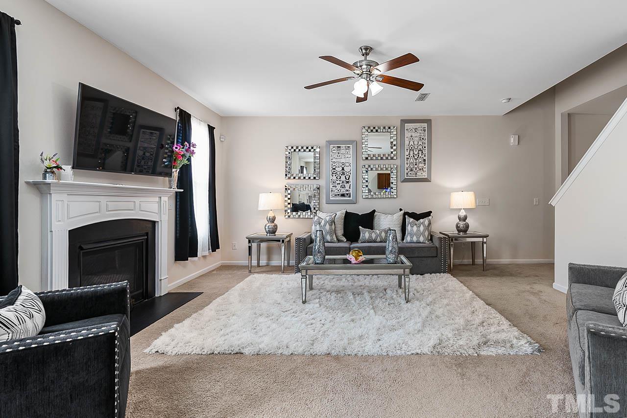 3540 Eastern Branch Road Raleigh, NC 27610 - Photo 13 of 35 a living room with furniture a fireplace and a flat screen tv