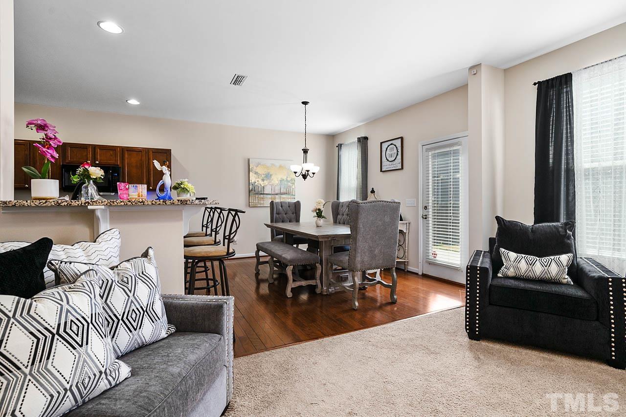 3540 Eastern Branch Road Raleigh, NC 27610 - Photo 16 of 35 a living room with furniture and a dining table with kitchen view