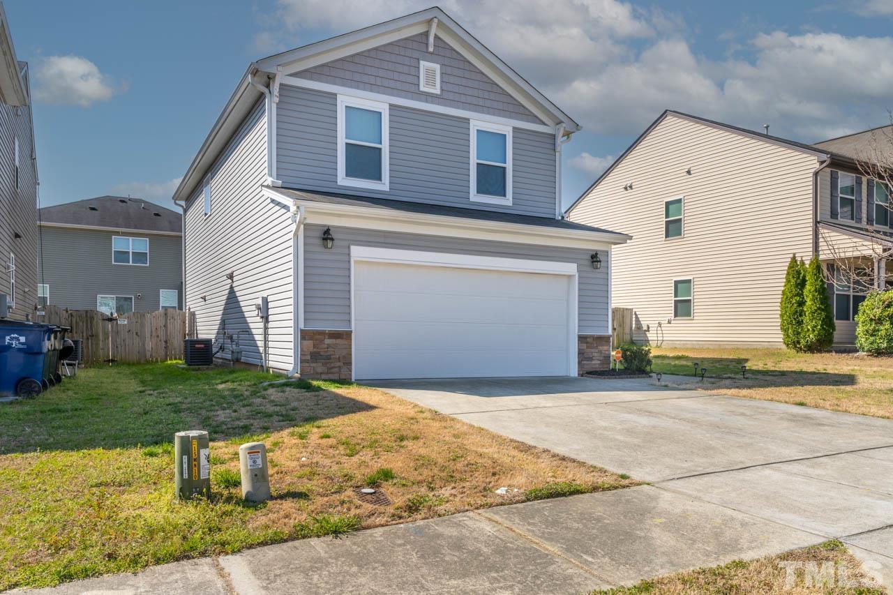 3540 Eastern Branch Road Raleigh, NC 27610 - Photo 2 of 35 a front view of a house with a yard and garage