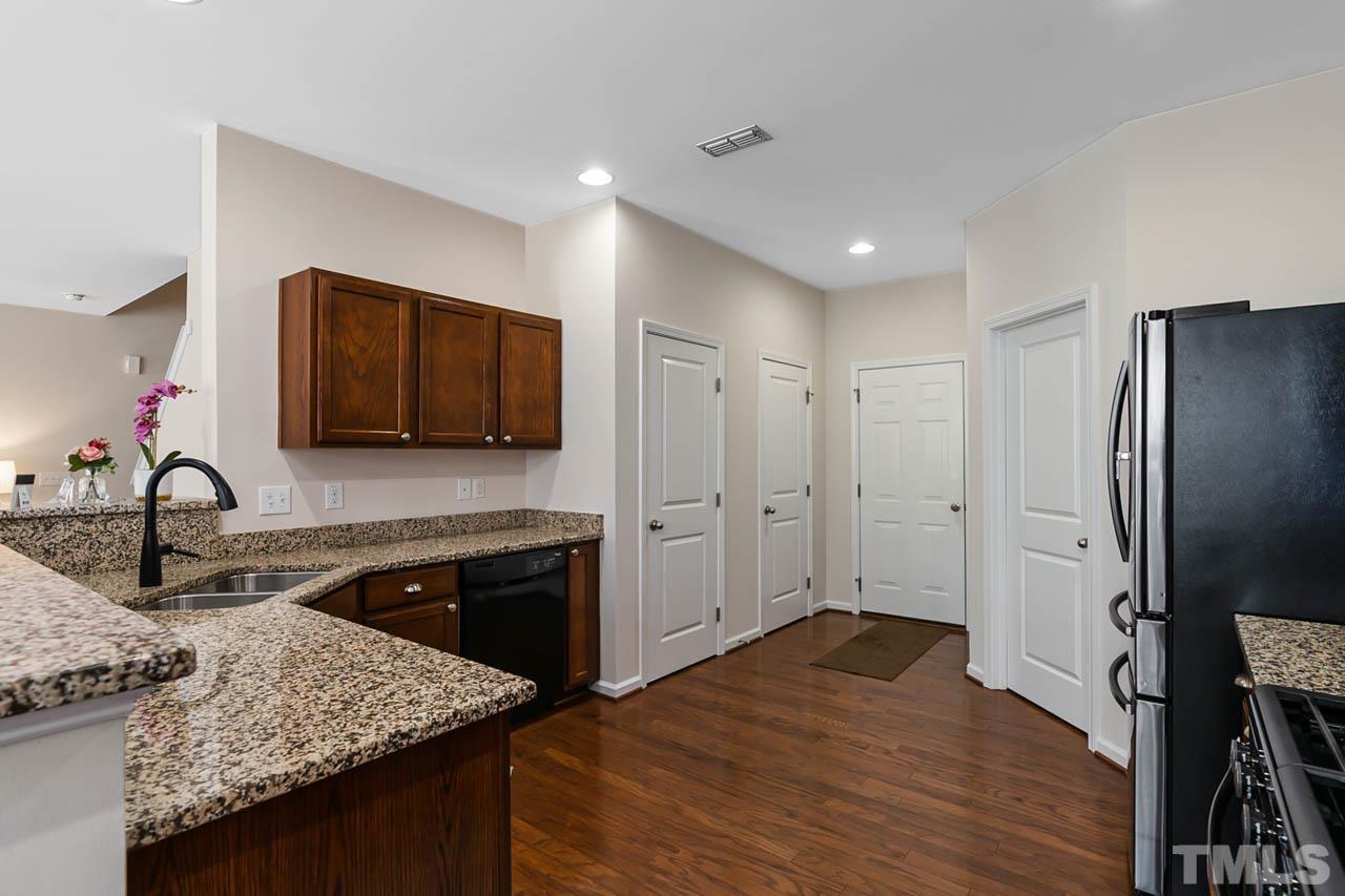 3540 Eastern Branch Road Raleigh, NC 27610 - Photo 21 of 35 a kitchen with stainless steel appliances granite countertop a sink stove and refrigerator