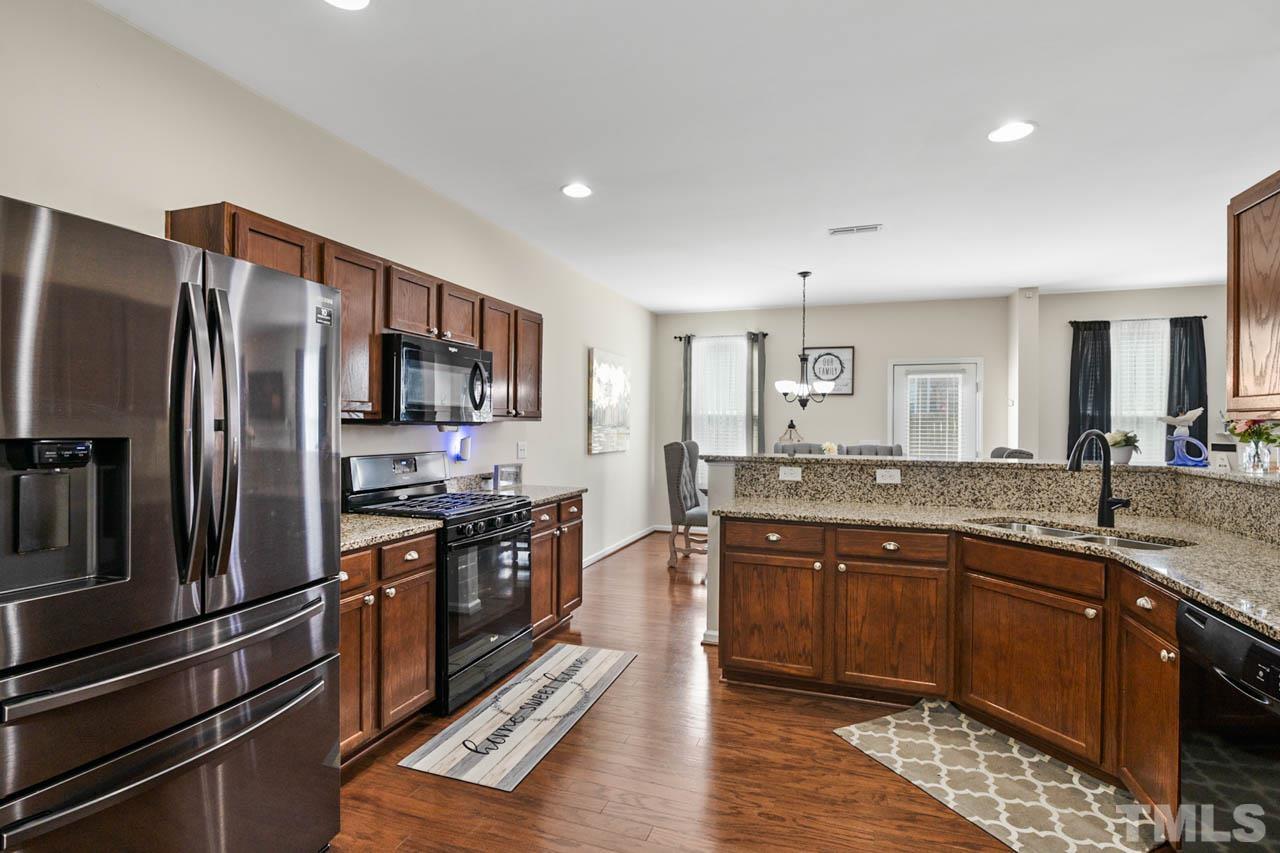 3540 Eastern Branch Road Raleigh, NC 27610 - Photo 22 of 35 a large kitchen with stainless steel appliances granite countertop a refrigerator and a sink