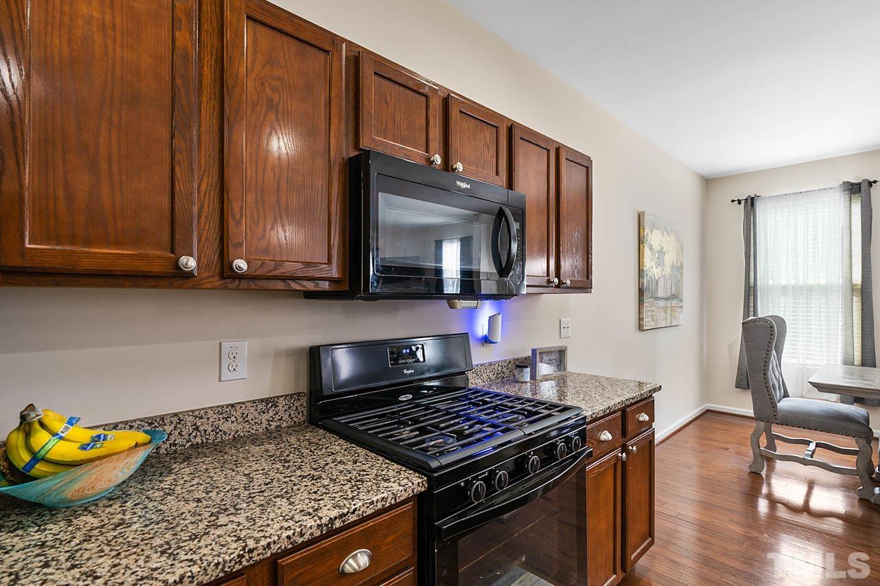 3540 Eastern Branch Road Raleigh, NC 27610 - Photo 23 of 35 a kitchen with stainless steel appliances granite countertop a stove a sink and a microwave