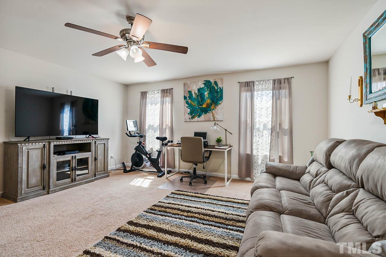 3540 Eastern Branch Road Raleigh, NC 27610 - Photo 27 of 35 a living room with furniture and a flat screen tv