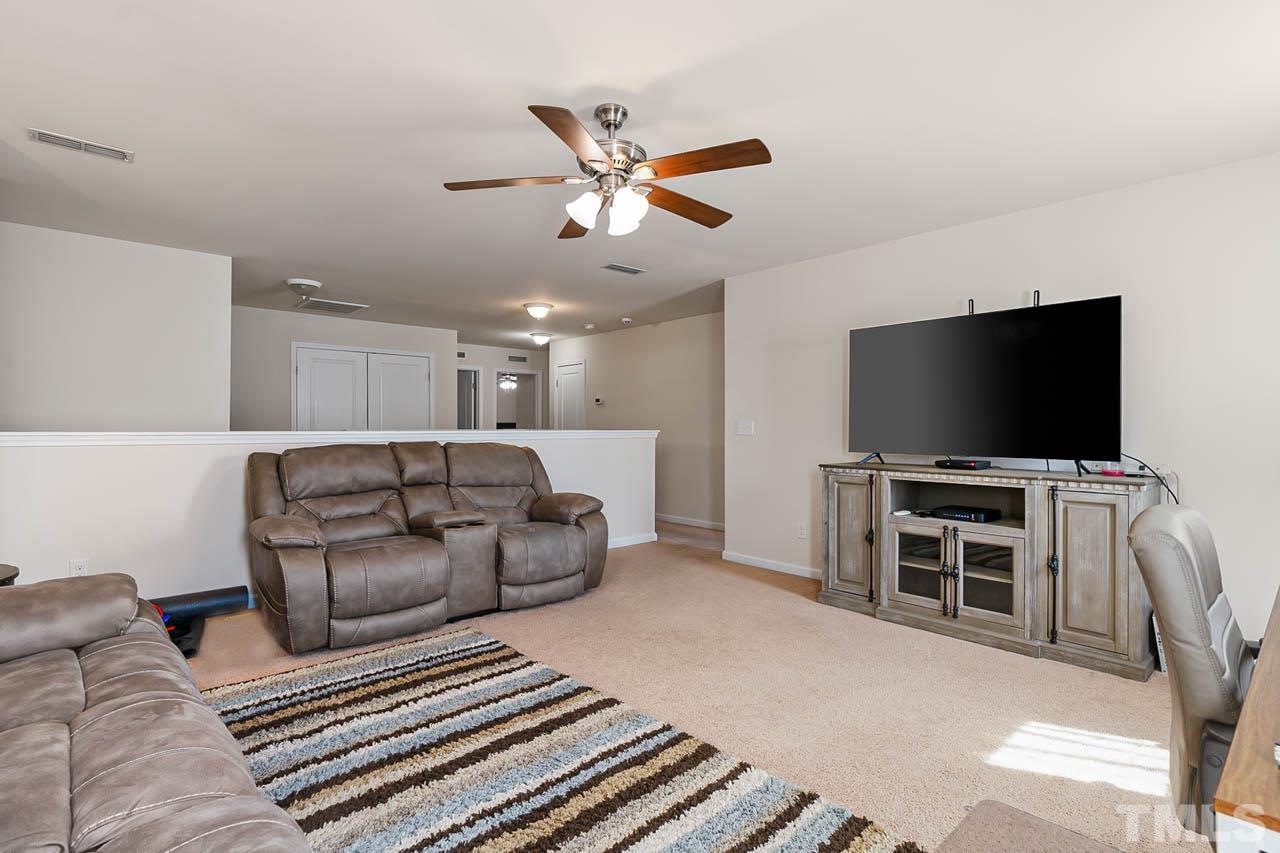 3540 Eastern Branch Road Raleigh, NC 27610 - Photo 28 of 35 a living room with furniture and a flat screen tv