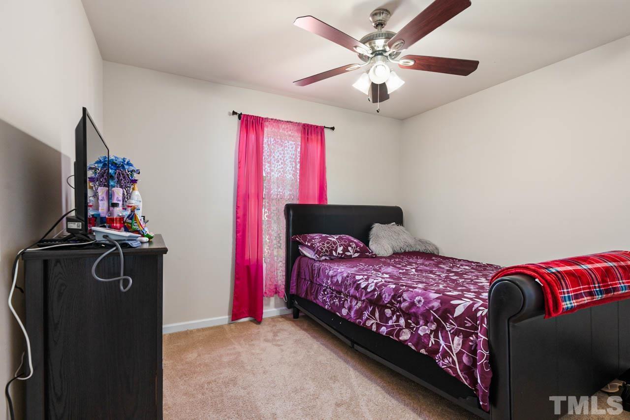 3540 Eastern Branch Road Raleigh, NC 27610 - Photo 29 of 35 a bedroom with a bed and a chandelier