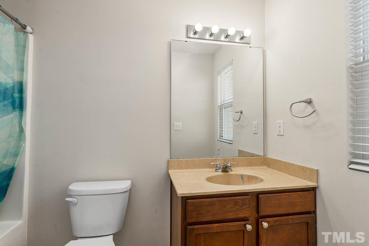 3540 Eastern Branch Road Raleigh, NC 27610 - Photo 30 of 35 a bathroom with a sink a toilet and mirror