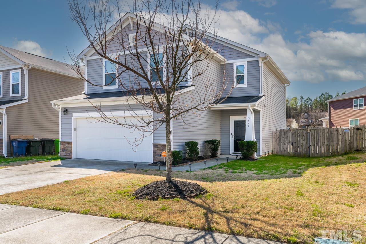 3540 Eastern Branch Road Raleigh, NC 27610 - Photo 3 of 35 a front view of a house with a yard and garage