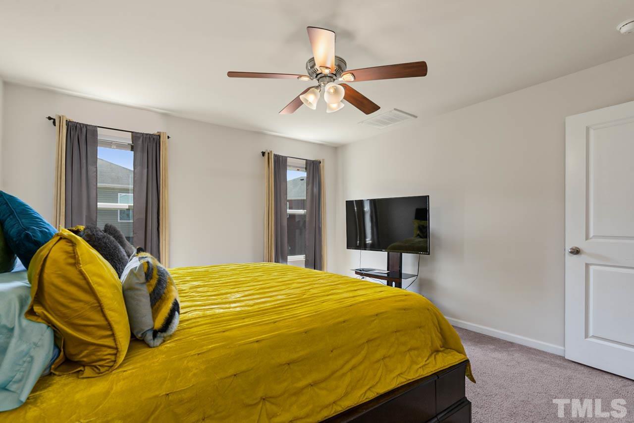 3540 Eastern Branch Road Raleigh, NC 27610 - Photo 32 of 35 a bedroom with a bed and a flat screen tv