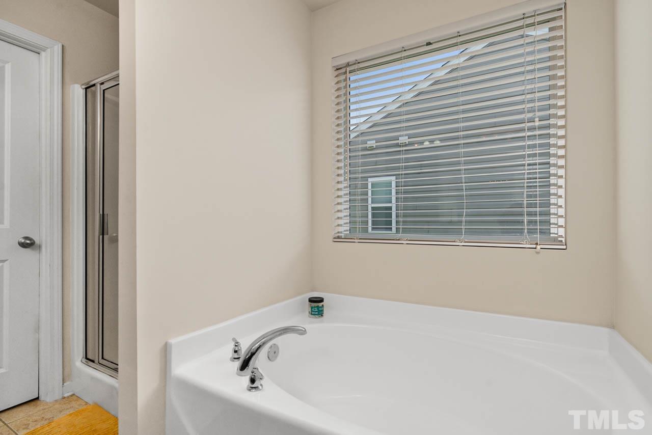 3540 Eastern Branch Road Raleigh, NC 27610 - Photo 34 of 35 a bathroom with a bathtub and a window