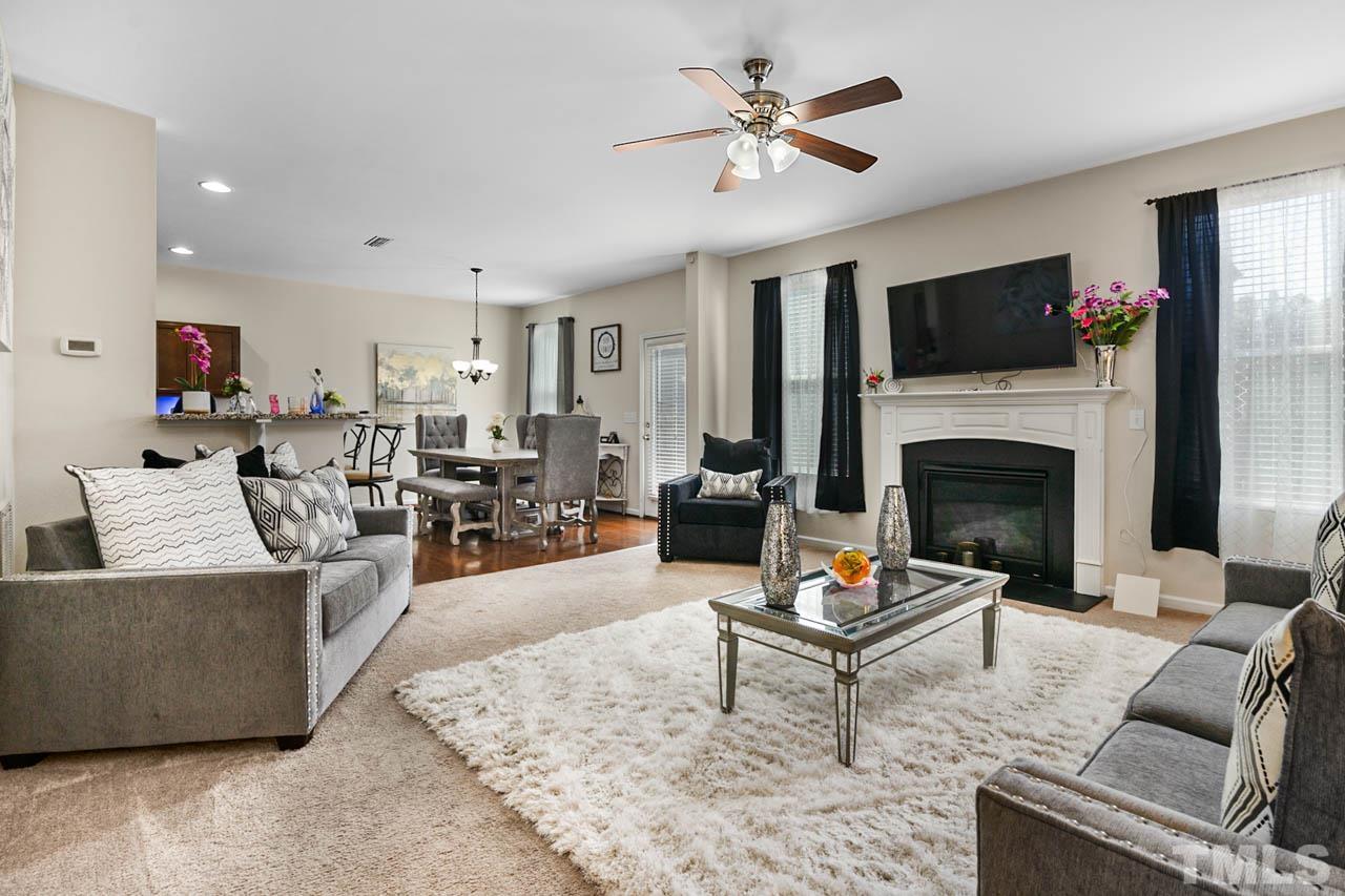 3540 Eastern Branch Road Raleigh, NC 27610 - Photo 10 of 35 a living room with furniture a flat screen tv and a fireplace
