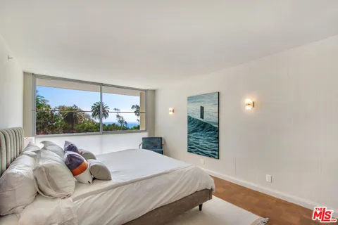a bedroom with bed and walk in closet